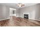 Spacious living room featuring hardwood floors, fireplace, and ceiling fan at 1111 Barrow Nook Ct, Apex, NC 27502