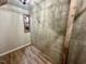 Unfinished basement with wooden floors, concrete walls, and a small storage nook at 1113 Bexley Hills Bend Bnd, Apex, NC 27502
