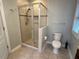 Bathroom featuring a glass shower and a toilet with a tiled floor and light gray walls at 1113 Bexley Hills Bend Bnd, Apex, NC 27502