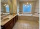 Bright bathroom with a large soaking tub, double vanity sinks and neutral color scheme at 1113 Bexley Hills Bend Bnd, Apex, NC 27502