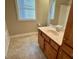 Bathroom featuring a window, a vanity sink, and a bathtub with shower head at 1113 Bexley Hills Bend Bnd, Apex, NC 27502