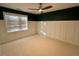 Neutral bedroom featuring dark accent wall, bright window, and ceiling fan at 1113 Bexley Hills Bend Bnd, Apex, NC 27502