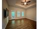 Bedroom with wood floors, a ceiling fan, and multiple windows providing ample natural light at 1113 Bexley Hills Bend Bnd, Apex, NC 27502