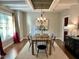 Bright dining room with hardwood floors, modern lighting, and many windows at 1113 Bexley Hills Bend Bnd, Apex, NC 27502