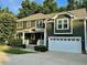 Charming two-story home with a two car garage and inviting curb appeal and mature trees in the background at 1113 Bexley Hills Bend Bnd, Apex, NC 27502