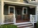 Inviting front porch with rocking chairs and a view of the front door, perfect for relaxing and enjoying the outdoors at 1113 Bexley Hills Bend Bnd, Apex, NC 27502