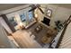 Aerial view of open concept living room featuring fireplace, many windows and modern decor at 1113 Bexley Hills Bend Bnd, Apex, NC 27502