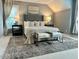 Inviting main bedroom with king bed, decorative lamps, and large area rug at 1113 Bexley Hills Bend Bnd, Apex, NC 27502
