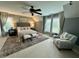 Large main bedroom with many windows, decorative lamps, and comfortable seating at 1113 Bexley Hills Bend Bnd, Apex, NC 27502
