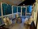 Outdoor screened porch featuring cozy seating and outdoor forest views at 1113 Bexley Hills Bend Bnd, Apex, NC 27502