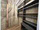 Wine cellar with custom built in shelving and a light fixture at 1113 Bexley Hills Bend Bnd, Apex, NC 27502