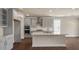 Spacious kitchen with an island, gray cabinetry, stainless steel appliances, and hardwood floors at 1113 Dartford Green Pl, Wake Forest, NC 27587