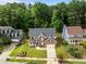 Charming brick home with a well-manicured lawn and inviting front porch, nestled among lush trees in a desirable neighborhood at 114 Council Gap Ct, Cary, NC 27513