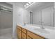 Bathroom featuring double vanity, wooden cabinets, and a large mirror at 114 Council Gap Ct, Cary, NC 27513