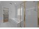 Bathroom showing tub, shower, glass block window, and walk-in closet at 114 Council Gap Ct, Cary, NC 27513