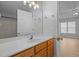 Bathroom vanity with a white countertop, wood cabinets, and gold fixtures and a view into the bonus room at 114 Council Gap Ct, Cary, NC 27513