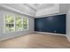 Bedroom showcasing hardwood floors, a tray ceiling, and natural lighting at 114 Council Gap Ct, Cary, NC 27513