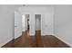 Cozy bedroom offering a view of the kitchen and other rooms; features neutral paint and hardwood floors at 114 Council Gap Ct, Cary, NC 27513