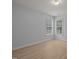 Bedroom with hardwood floors, two windows, and light gray walls at 114 Council Gap Ct, Cary, NC 27513