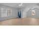 Bonus room with two windows, luxury vinyl plank flooring, a ceiling fan, and high vaulted ceilings at 114 Council Gap Ct, Cary, NC 27513