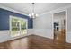 Dining room with natural light, wood floors, chandelier, and views into the living spaces at 114 Council Gap Ct, Cary, NC 27513