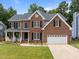 Charming brick home featuring a manicured lawn and an attached two-car garage at 114 Council Gap Ct, Cary, NC 27513