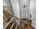A foyer and staircase with decorative metal balusters and a large light fixture hanging above the entryway at 114 Council Gap Ct, Cary, NC 27513