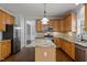 Kitchen with stainless steel appliances, granite countertops, and custom wood cabinetry at 114 Council Gap Ct, Cary, NC 27513