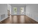 Bright living area with hardwood floors, wainscoting, and lots of natural light from the windows at 114 Council Gap Ct, Cary, NC 27513