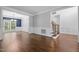 Open living area with hardwood floors and a view of the dining room and staircase at 114 Council Gap Ct, Cary, NC 27513