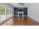 Living room boasts a cozy fireplace, large window, and hardwood floors at 114 Council Gap Ct, Cary, NC 27513