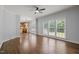 Bright living room featuring hardwood floors, large windows, and an open floor plan leading to the kitchen at 114 Council Gap Ct, Cary, NC 27513