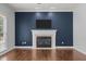 Living room features a fireplace, modern aesthetic, and hardwood floors at 114 Council Gap Ct, Cary, NC 27513