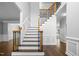 Beautiful staircase featuring wooden steps, white risers, and a decorative wrought iron railing at 114 Council Gap Ct, Cary, NC 27513