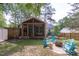 Backyard sitting area featuring Adirondack chairs arranged around a stone fire pit at 1209 Edgevale Rd, Durham, NC 27701