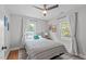 Bright bedroom features hardwood floors, natural lighting, and gray accent wall at 1209 Edgevale Rd, Durham, NC 27701