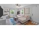 Well-lit living room with stylish decor, hardwood floors, and large windows with tree views at 1209 Edgevale Rd, Durham, NC 27701