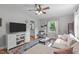 Cozy living room open to kitchen, showcasing wood floors and open concept design at 1209 Edgevale Rd, Durham, NC 27701