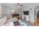 Comfortable living room with stylish rug, ceiling fan, and a view into the kitchen at 1209 Edgevale Rd, Durham, NC 27701