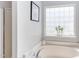 Bright bathroom features a modern tub, a large window and clean, neutral decor at 12320 Tetons Ct, Durham, NC 27703