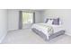Bedroom with large window and neutral carpeting; brightly and neutrally decorated at 12320 Tetons Ct, Durham, NC 27703