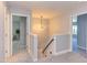 Bright, carpeted hallway with open doorways and a modern light fixture creating a welcoming space at 12320 Tetons Ct, Durham, NC 27703