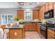 Cozy kitchen with stainless steel stove and cabinets with a kitchen island and decor at 12320 Tetons Ct, Durham, NC 27703