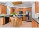 Well-lit kitchen with stainless steel appliances and wood cabinets, offering ample counter space at 12320 Tetons Ct, Durham, NC 27703
