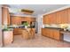 Bright kitchen featuring wooden cabinetry, an island with seating, and modern appliances at 12320 Tetons Ct, Durham, NC 27703