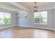 Bright living room with wood floors, gray walls, white trim and lots of natural light at 12320 Tetons Ct, Durham, NC 27703