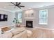 Inviting living room with fireplace, TV, and multiple windows with natural light at 12320 Tetons Ct, Durham, NC 27703