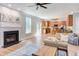 Bright living room with a fireplace and an open view to the kitchen area at 12320 Tetons Ct, Durham, NC 27703