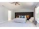 Bright main bedroom featuring a large bed, custom headboard, and big sunny window at 12320 Tetons Ct, Durham, NC 27703