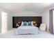A well lit main bedroom features a large bed with a decorative black headboard at 12320 Tetons Ct, Durham, NC 27703